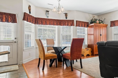 Dining room featuring a chandelier and wood finished floors