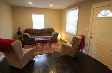 Spacious and inviting Living Room. Original hardwood floors throughout the house. 