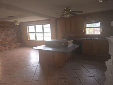 Kitchen with tile patterned floors, ceiling fan, s