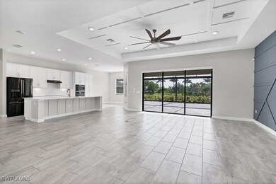 Unfurnished living room featuring a tray ceiling,