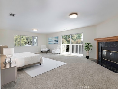 Master Bedroom, Fireplace, Sliding Glass Door onto Balcony.  Virtually staged.