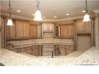 Looking over the breakfast bar into the kitchen. There will be a built oven and microwave to the right, a cook-top with a pot-filler above it and a tile back splash.