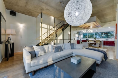 Living room featuring wood-type flooring and a chandelier