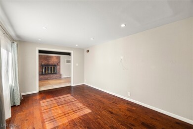 Spare room featuring a fireplace, baseboards, and