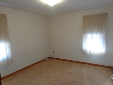 Main floor master bedroom with warm sandy beige wa