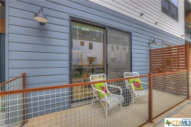 Patio off from of condo that looks out to the pool