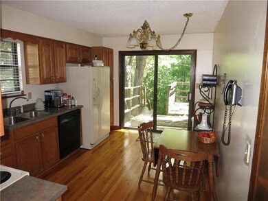 Well lit kitchen with wood flooring and overlooks 