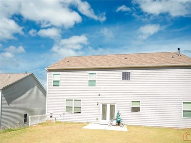 Rear view of property with a patio area and a lawn