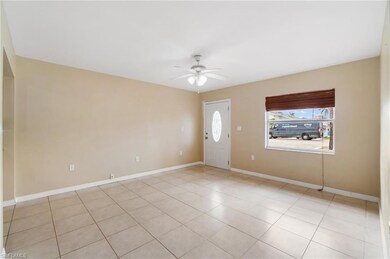 Unfurnished room with baseboards, ceiling fan, and