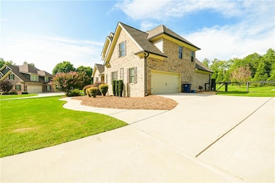 View of property exterior with a garage and a lawn