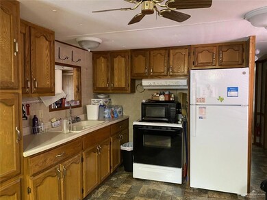 Kitchen with conveying refrigerator and stove