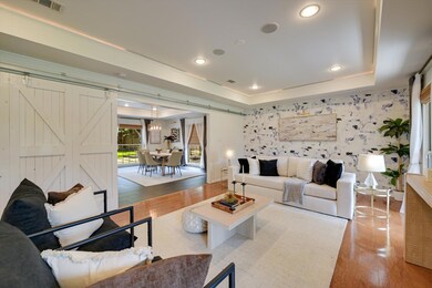 Living room with wood finished floors, an accent 
