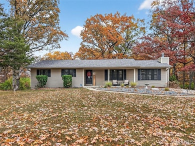 Ranch-style house featuring a chimney