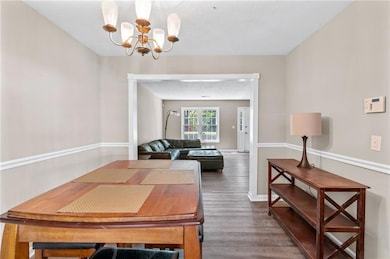 Dining area featuring dark wood finished floors, b