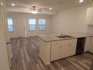 Kitchen with dark wood finished floors, dishwasher