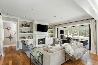 Main level receives abundant natural light and was made for everyday living and entertaining. Accordion doors open to the screened porch with wood fireplace.