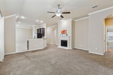 Spacious living area with a pretty fireplace and lots of space.