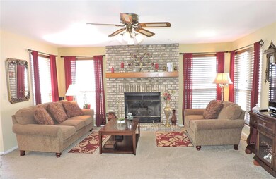 Family room with a Brick fireplace and wood mantle