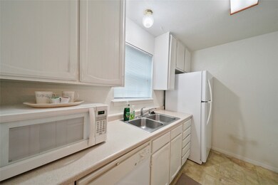 Sleek white appliances match kitchen perfectly. Br