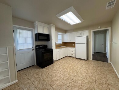 Kitchen with light tile patterned floors, visible 