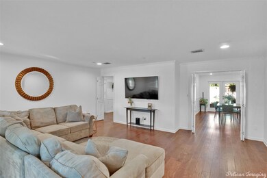 Living room with french doors, wood-type flooring,