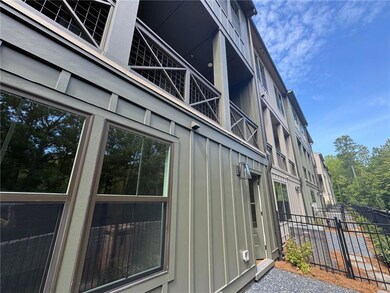 View of property exterior with board and batten siding and a balcony