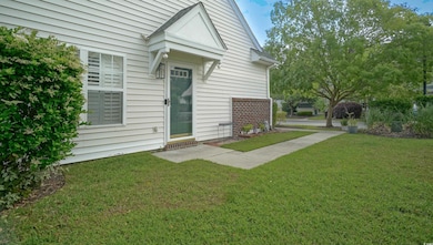 View of exterior entry with a yard