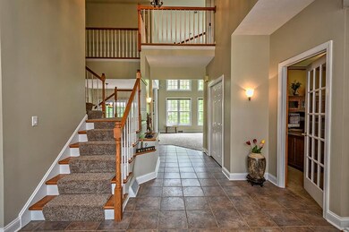 Dual staircase from the entry and kitchen areas le