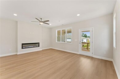Spacious family room with electric fireplace.  Fireplace is great for ambience, or you can use to warm up.