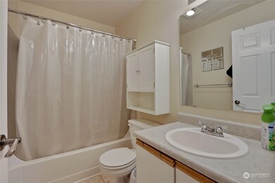 The main bathroom conveniently located off the hall.  This bathroom features a combination tub and shower and single vanity.