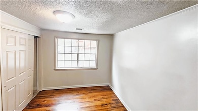 Unfurnished bedroom featuring a closet, baseboards