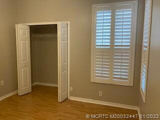GUEST BEDROOM. PLANTATION SHUTERS ON THE WINDOWS AND A FAN.