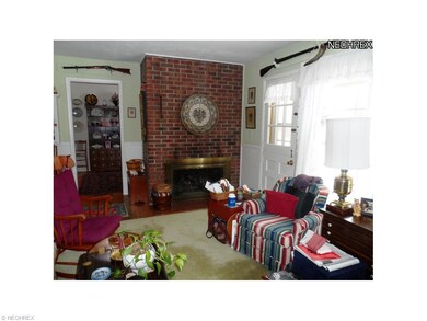 Family rm with gas fireplace leading outside to br