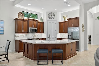 Open Kitchen with Pantry, Breakfast Bar, Newer Stainless Steel Appliances, Quartz countertops and Backsplash, and Under/Above Cabinet Accent Lighting