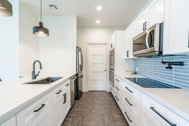 Kitchen featuring a sink, visible vents, white ca