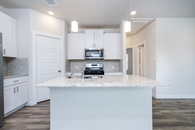 lovely quartz, white cabinets, and trendy backsplash