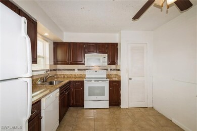 Kitchen featuring sink, tasteful backsplash, light