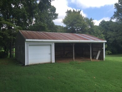 The enclosed area of this shop is where the previous owner did all of his woodworking. You've also got 3 large bays to park your tractor and finishing mower!