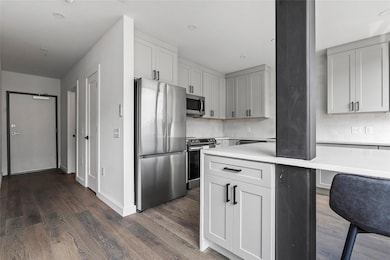 Kitchen featuring stainless steel appliances, tas
