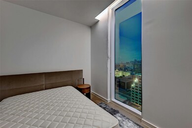 Bedroom with baseboards and wood finished floors