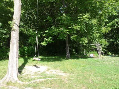 Lots of trees to the side and back of the house.