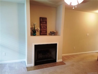 Gas log fireplace has space for TV overtop.