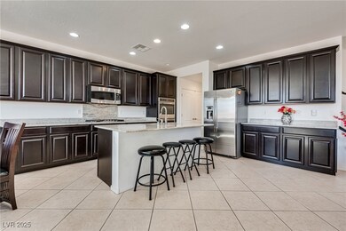 Kitchen with visible vents, a center island with s