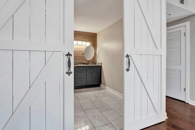 Bathroom featuring vanity, hardwood / wood-style f