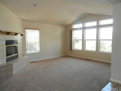 Large front windows with treed view &  cozy firepl