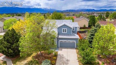 View of front of house featuring driveway, a mountain view, an attached garage, and a shingled roof