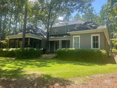 Back of property with a lawn