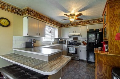 Kitchen with counter to eat in and appliances stay