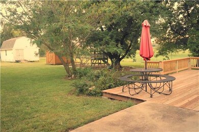Patio and New deck play set and two out buildings.