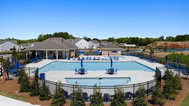 Community pool with fence and a patio